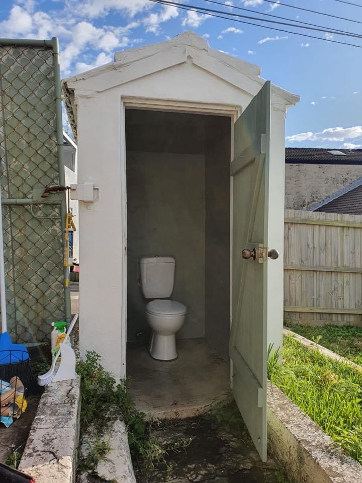 A backyard outhouse with a new toilet fitted